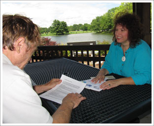 Susan Wright with a client, counseling sessions are sometimes held outdoors.