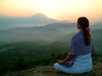woman meditating at dawn